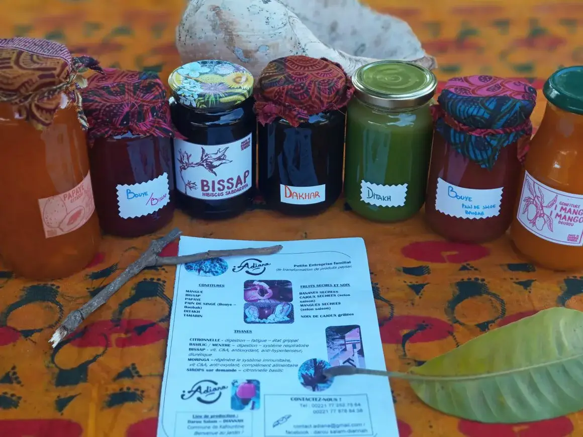 Bocaux de confitures et jus artisanaux de la petite entreprise Adiana, présentés avec un dépliant