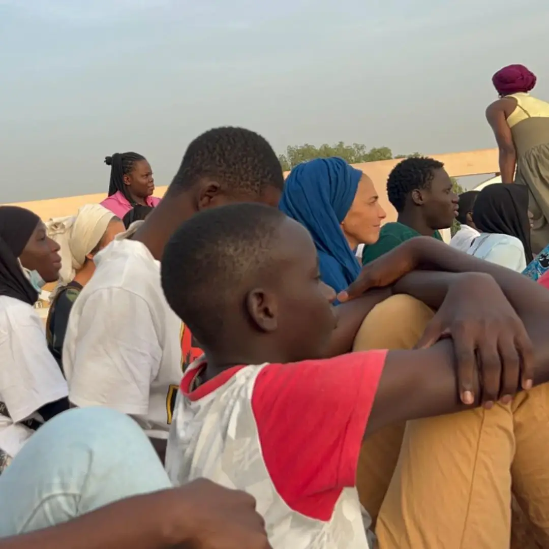 Un groupe de jeunes et d’adultes assis, attentifs lors d’une rencontre