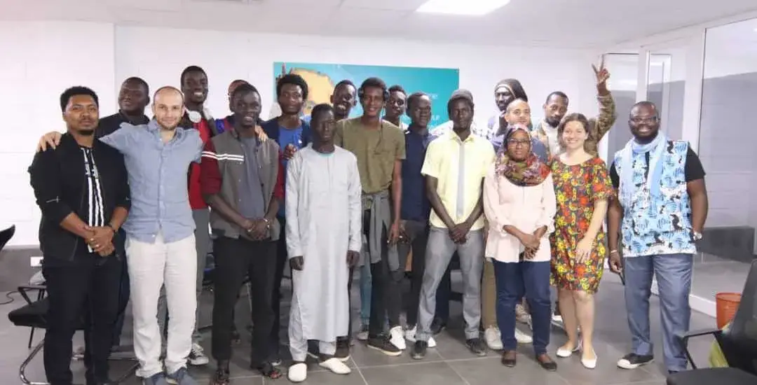 Les participants du Global Game Jam à Dakar posent devant un écran.